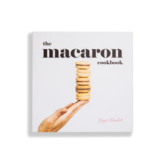 Ginger Elizabeth Chocolates Macaron Cookbook on white background cover art features stack of macaron cookies