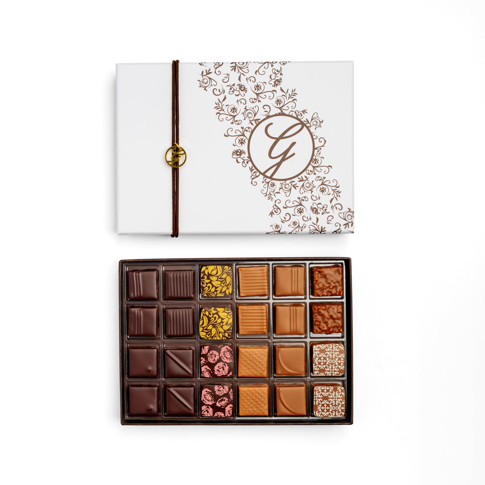 open 24-piece chocolate box arranged below closed box on white background