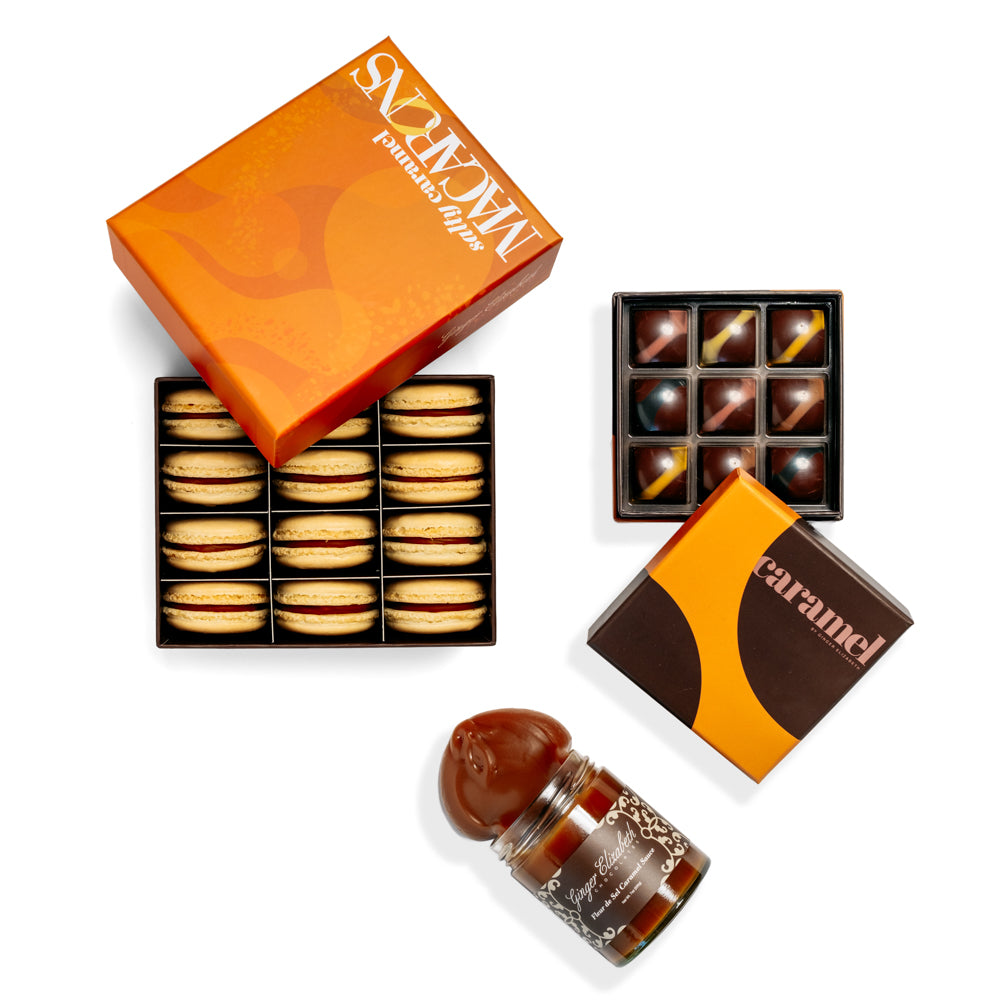 12 piece open box of salty caramel macarons, 9-piece open box of chocolate caramels and jar of caramel sauce on white background