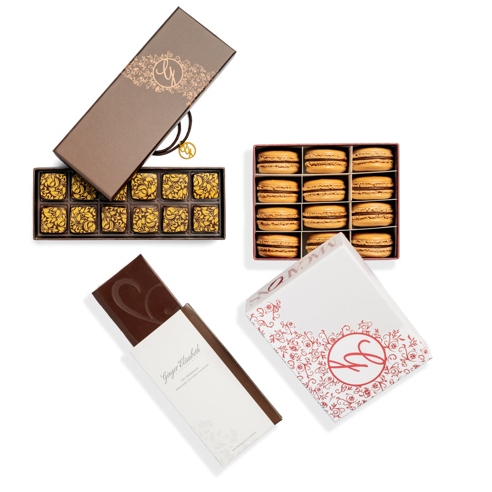 12 piece box of chocolates, 12 piece box chocolate macarons and chocolate bar on white background.