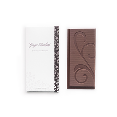 Ginger Elizabeth Chocolates Candied Coconut and Kaffir Lime Chocolate Bar and packaging on white background.