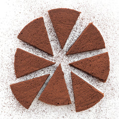Ginger Elizabeth Chocolates Gateau Maison cake sliced on white background