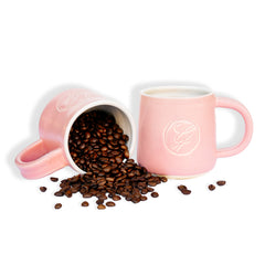 Ginger Elizabeth Chocolates pink ceramic logo mugs with coffee beans on white background 