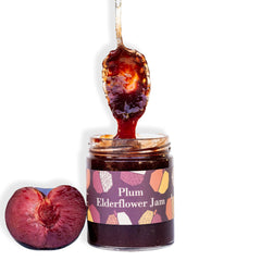 Ginger Elizabeth Chocolates Plum Elderflower Jam jar with fresh plum and dipped spoon on white background