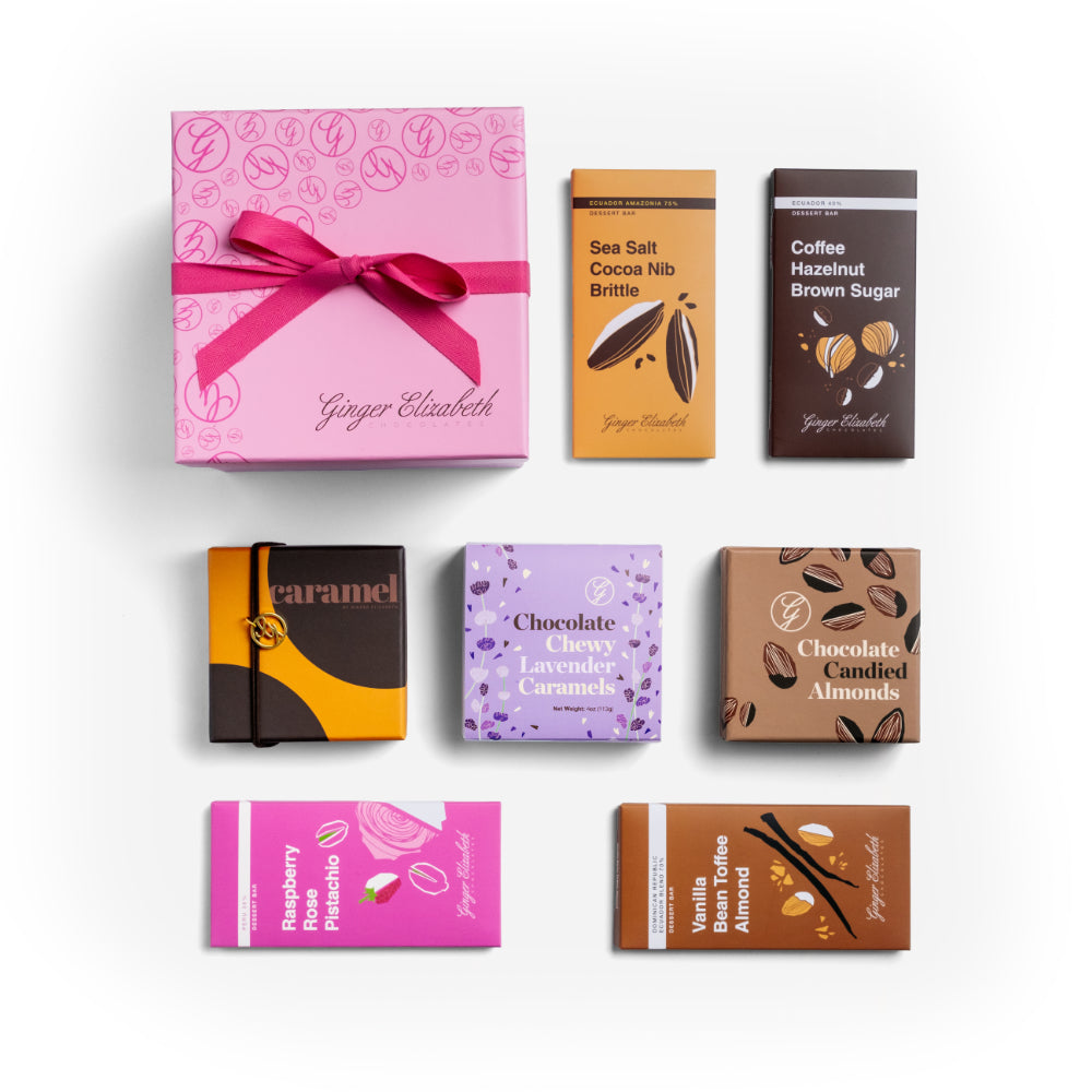 Pink gift box with a bow surrounded by various chocolate bars on a light background