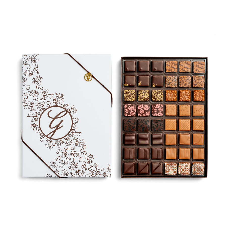 open 48-piece chocolate box arranged below closed box on white background