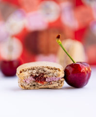 ginger elizabeth chocolates buckwheat bing cherry macaron cookie with bite out and cherry 