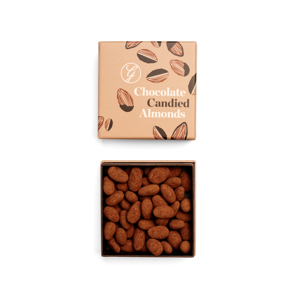 Box of chocolate candied almonds with a matching packaging box on a white background