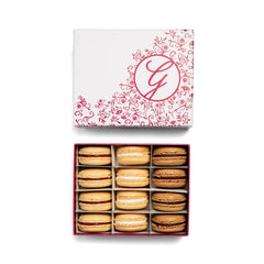 Ginger Elizabeth Chocolates 12 Piece open box of Macarons and lid with pink floral G logo on white background