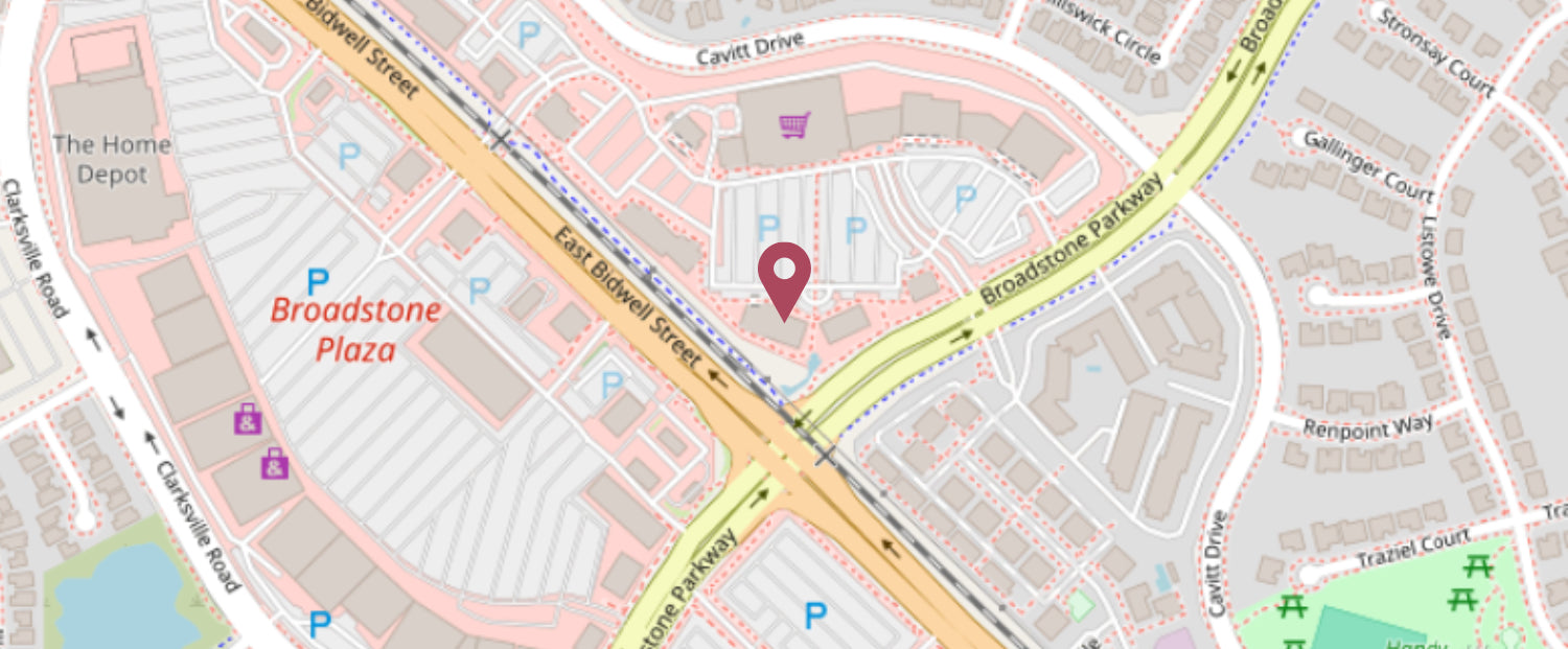 A digital map showing a street layout with roads, buildings, and a red pin marker at the center. Visible place names include Broadstone Plaza, Broadstone Parkway, and various streets in a suburban area.