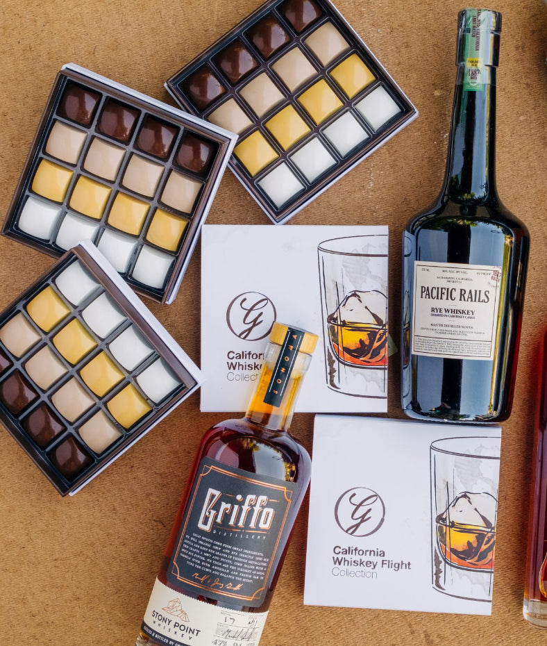 16 piece whiskey collection chocolate boxes and whiskey bottles on brown background