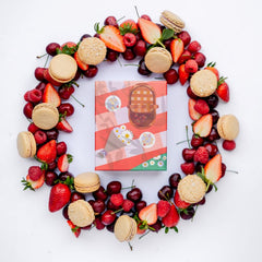 ginger elizabeth chocolates summer macaron box surrounded by macaron cookies and fresh fruit on white background