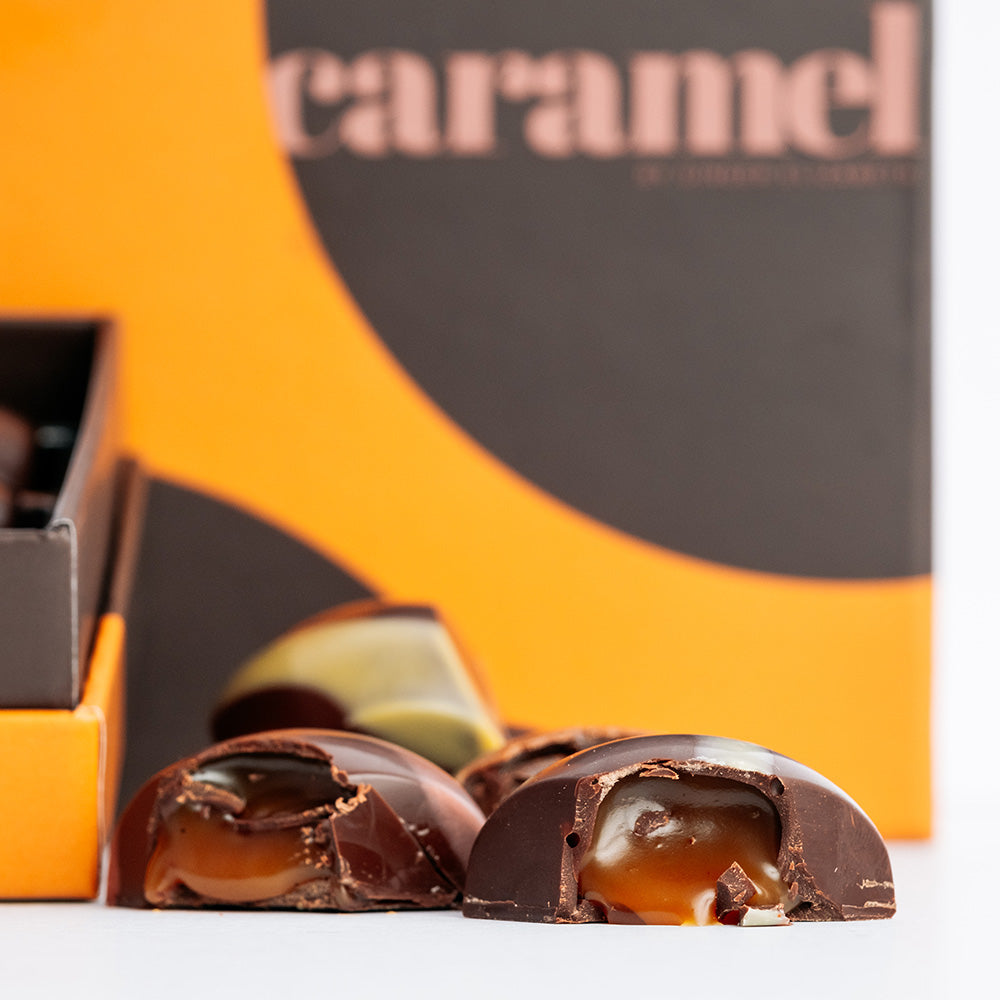 Close cropped Ginger Elizabeth Chocolates caramel collection chocolates aranged in front of box. 