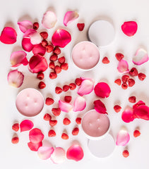 Ginger Elizabeth Chocolates Raspberry Rose Bonbon Candles shown with fresh raspberries and rose petals